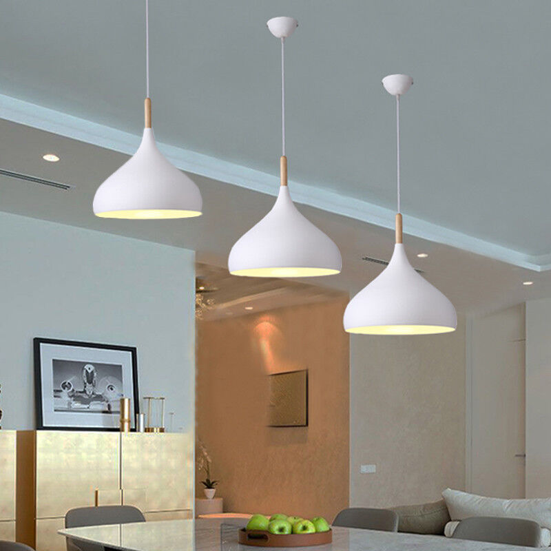 Wooden bar lamp trio casting a warm glow in a modern kitchen.